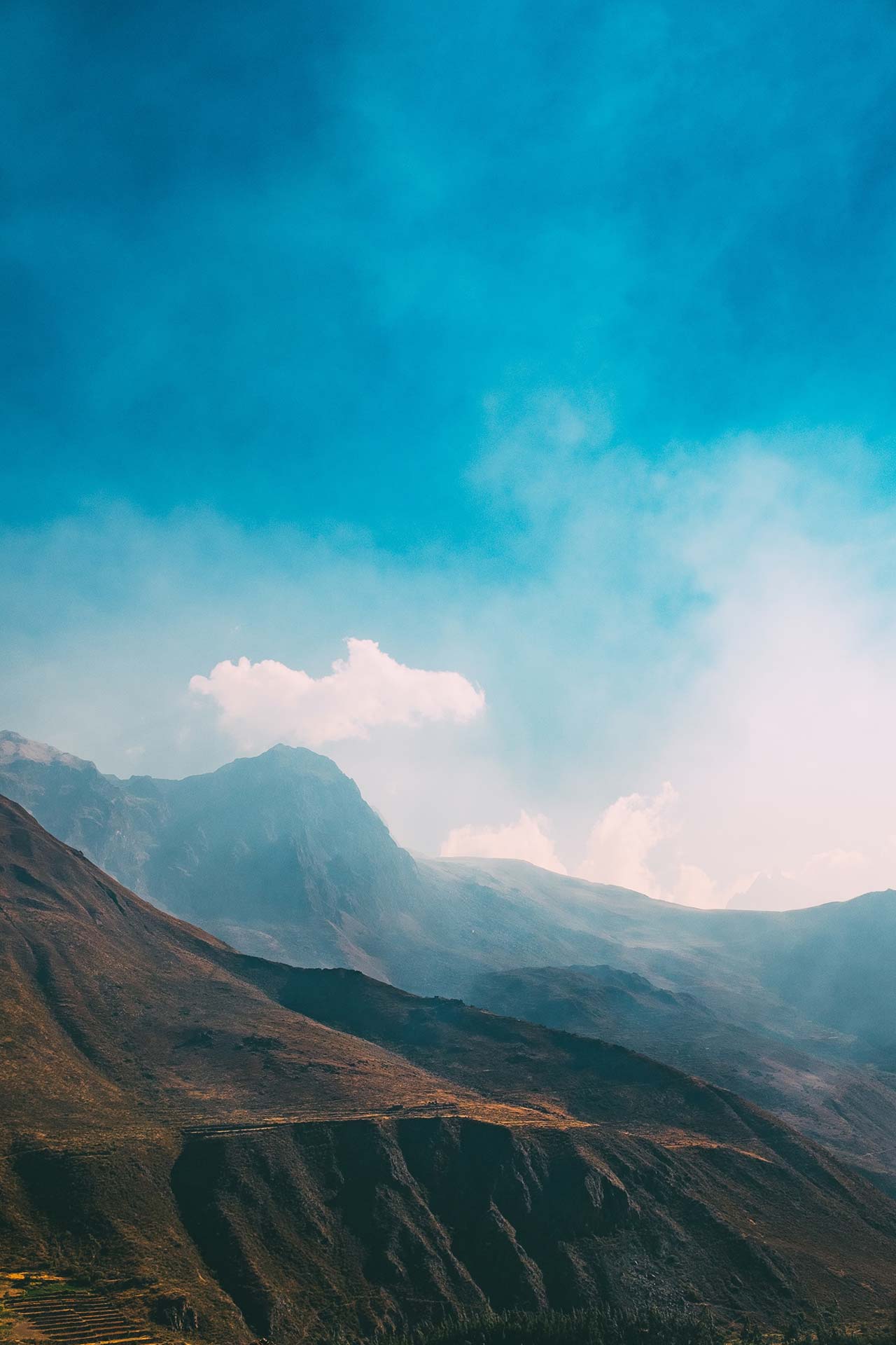 Layered mountains under vibrant blue sky