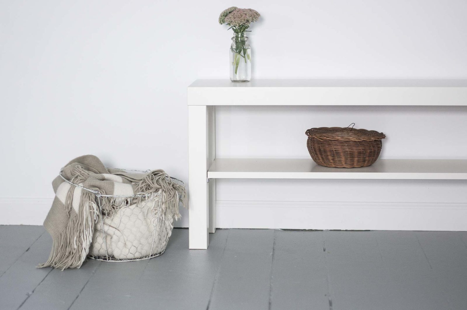 White bench with wicker basket and vase